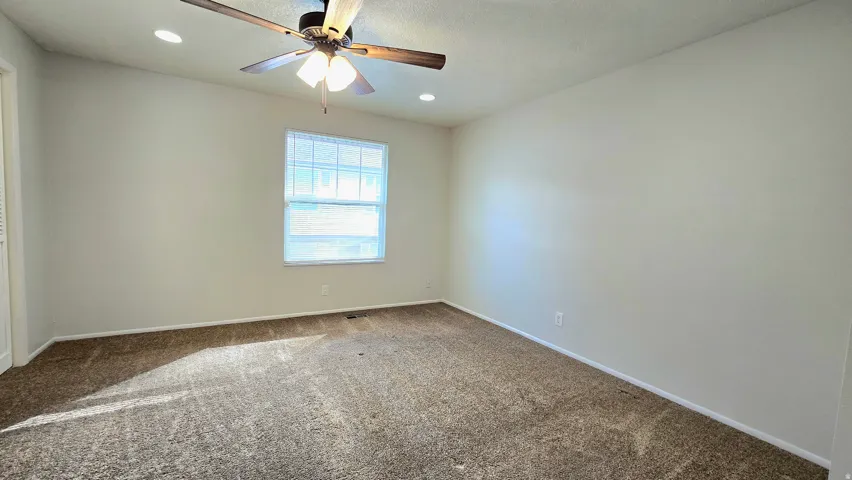 Unfurnished room with ceiling fan, carpet flooring, and recessed lighting