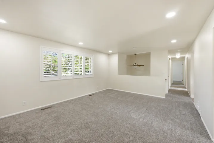 Carpeted empty room with recessed lighting and a ceiling fan