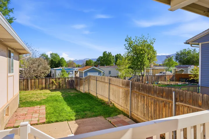 Fenced backyard featuring a mountain view
