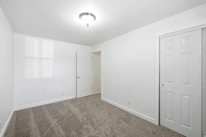 Unfurnished bedroom featuring baseboards and carpet floors