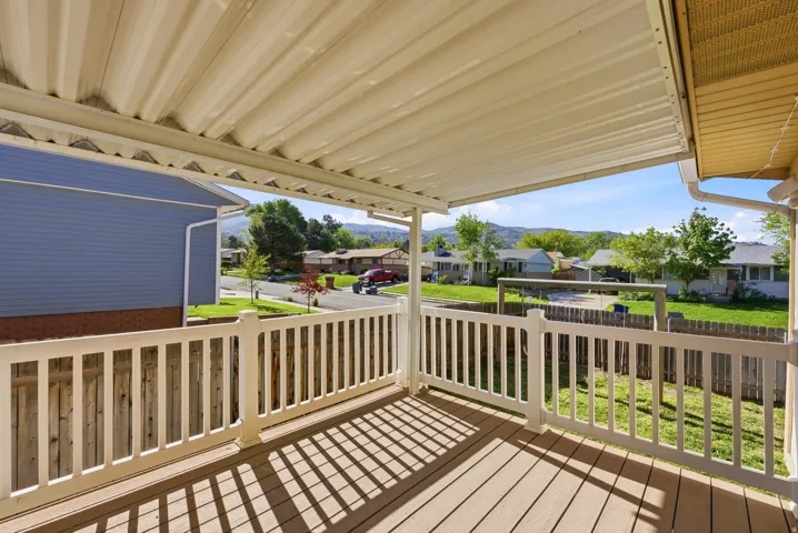 Wooden deck with a residential view and a mountain view