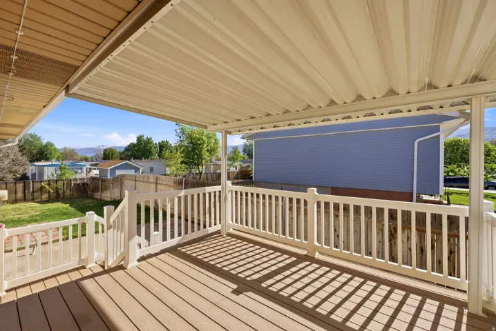 Deck featuring a fenced backyard and a mountain view