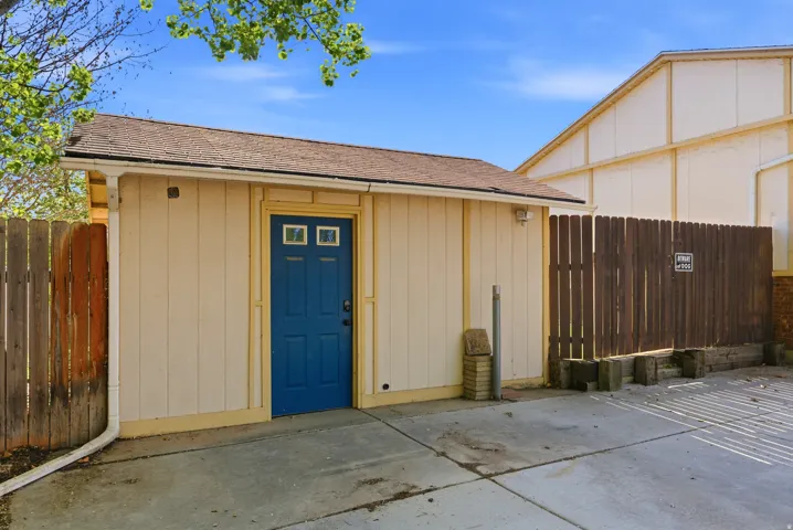 Doorway to property with a shingled roof