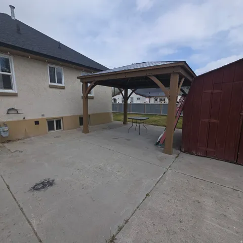View of patio with a gazebo and a storage shed
