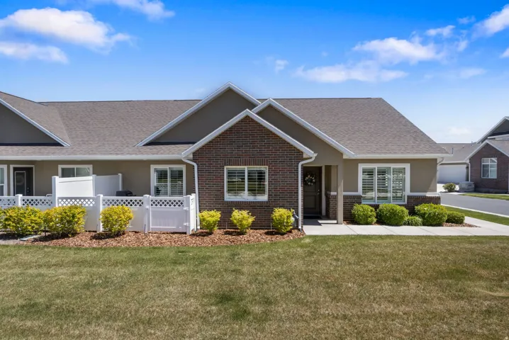 Ranch-style house featuring brick siding and roof with shingles