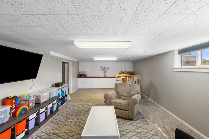 Sitting room featuring light carpet and baseboards