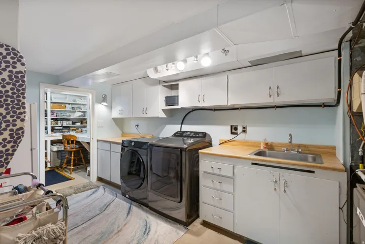 Laundry area featuring cabinet space and washing machine and clothes dryer