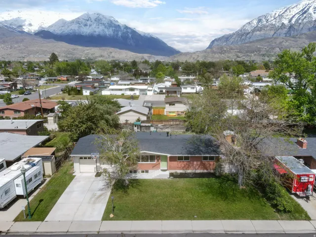 Aerial perspective of suburban area featuring a mountain backdrop