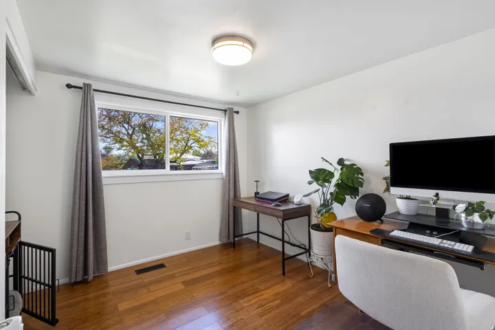 Office featuring hardwood / wood-style flooring and baseboards
