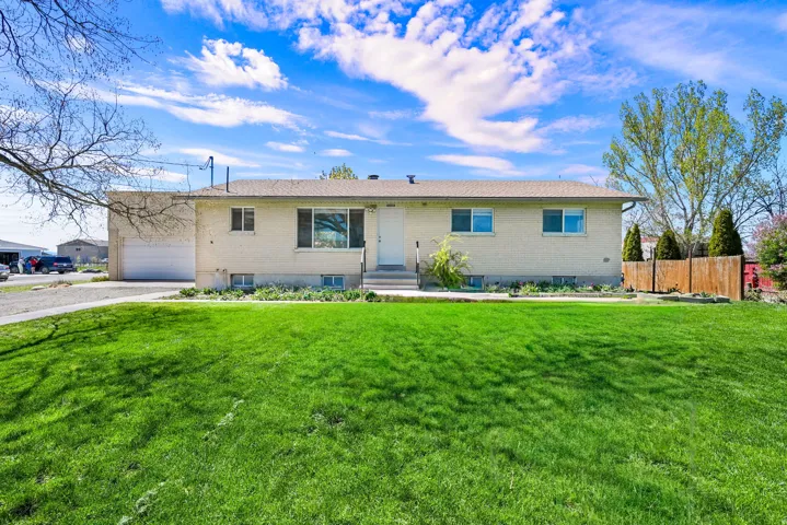 Ranch-style house with brick siding, driveway, and an attached garage