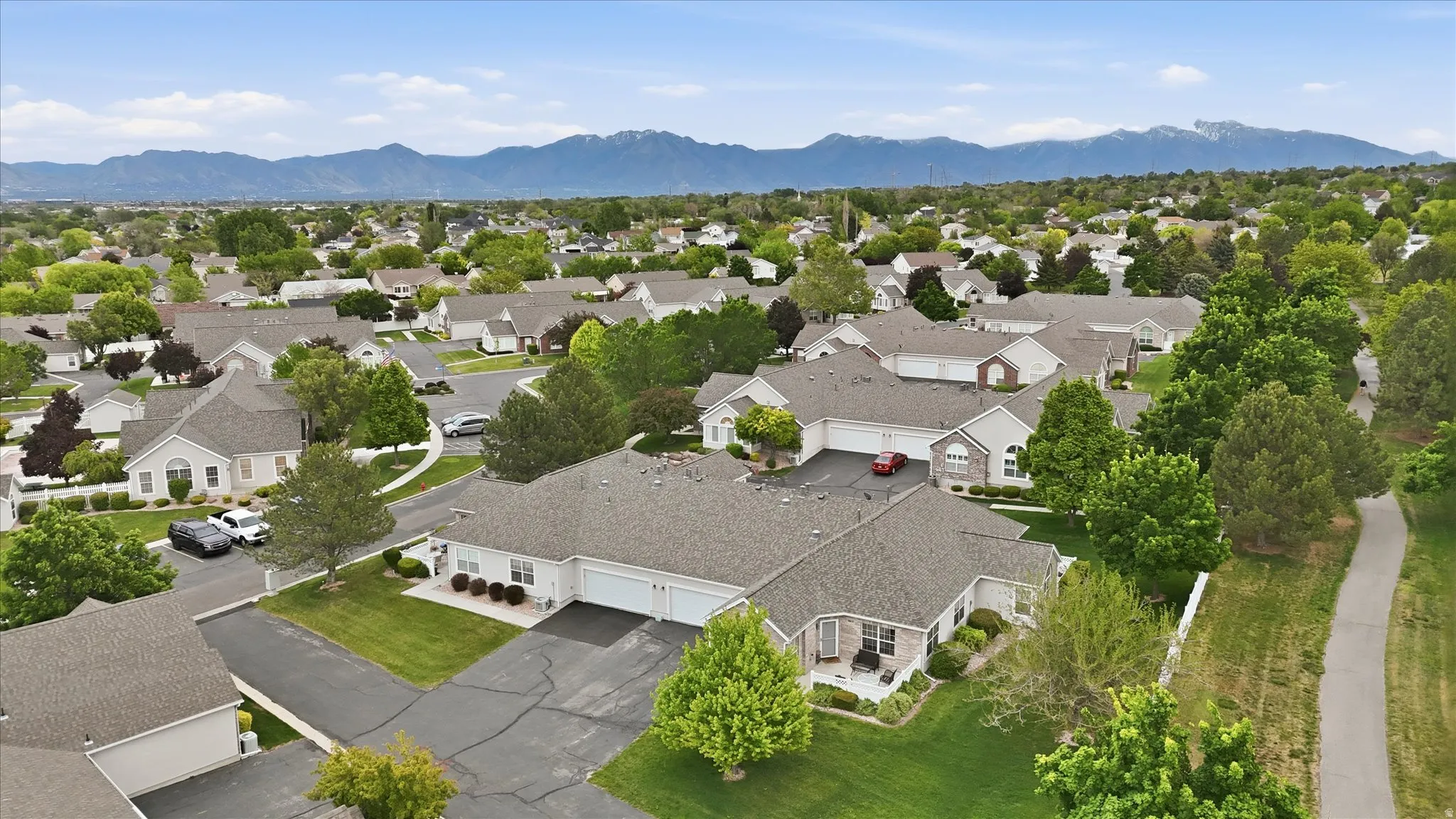 Aerial perspective showcasing a residential community with varied architectural styles and mature landscaping
