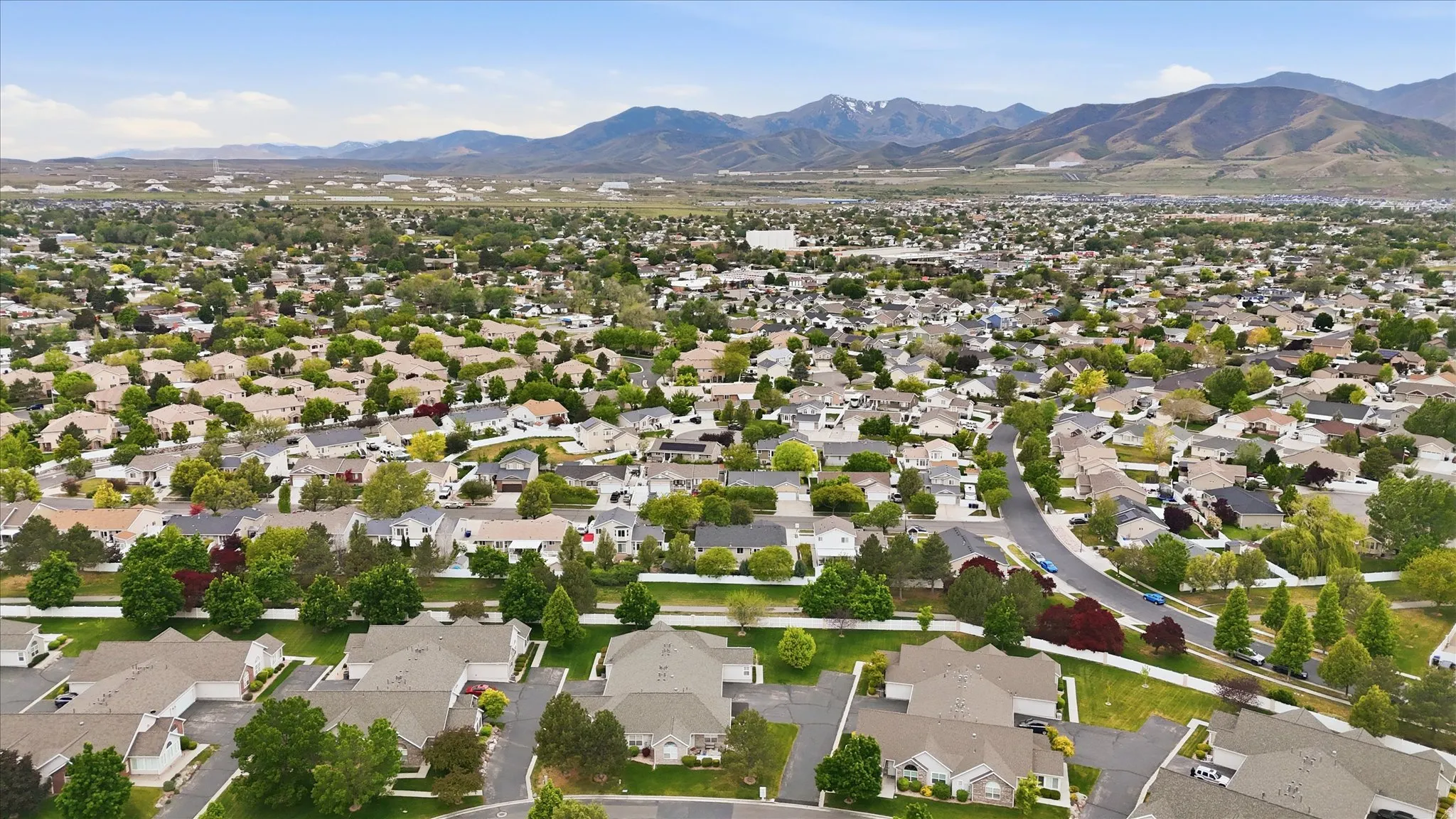 Expansive residential area featuring numerous single-family homes, mature landscaping, and curved streets