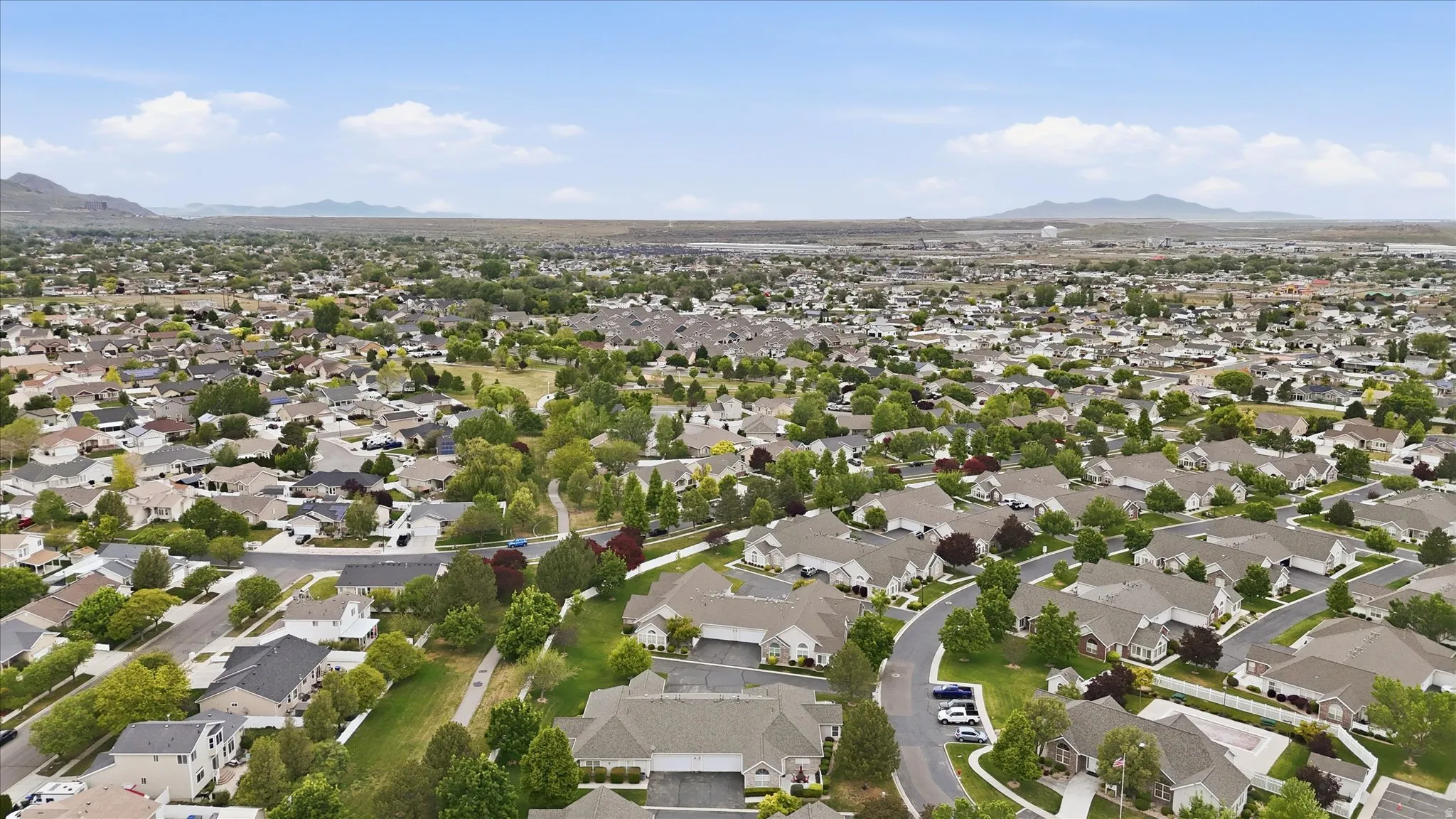 Residential neighborhood featuring numerous single-family homes with mature trees and paved streets