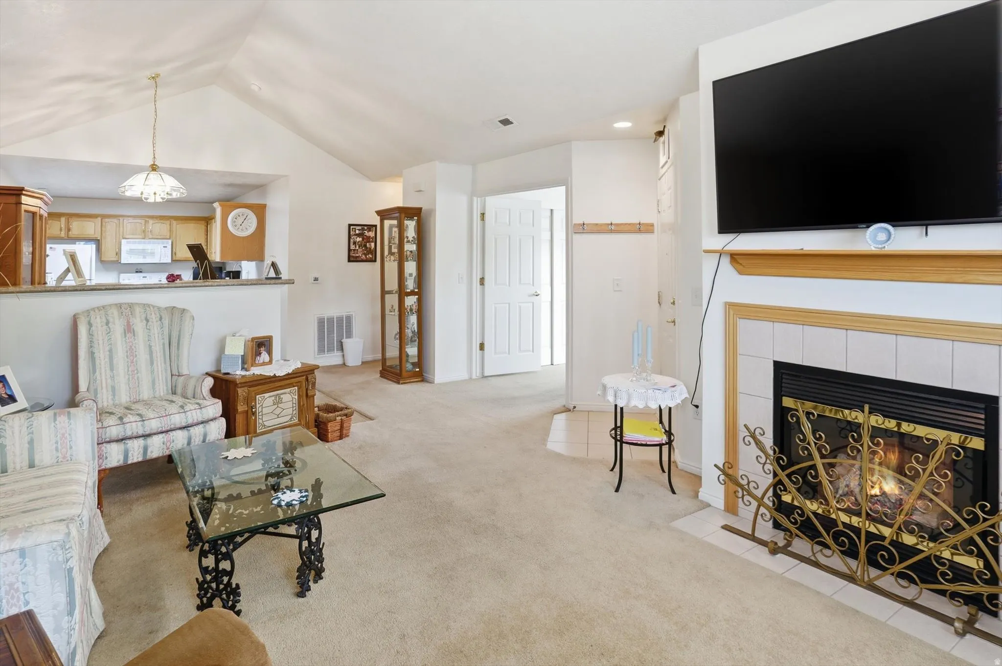 Living area featuring a fireplace with a tile surround and wood mantel