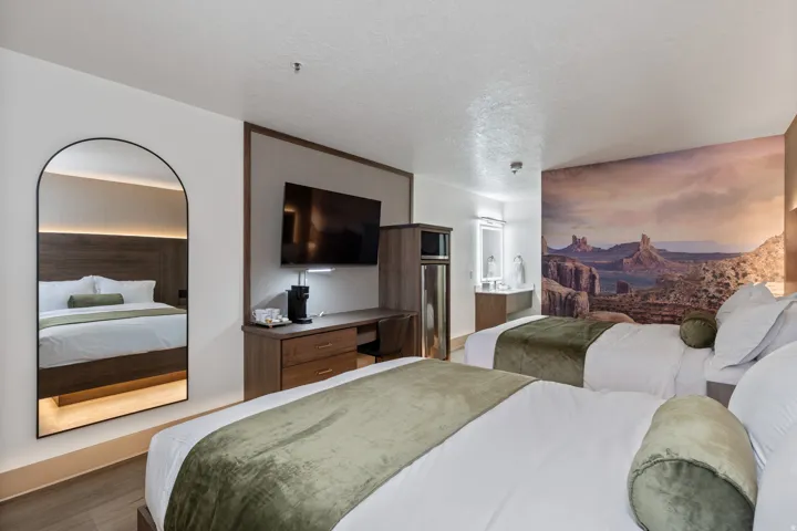 Bedroom with a textured ceiling, wood finished floors, and ensuite bathroom