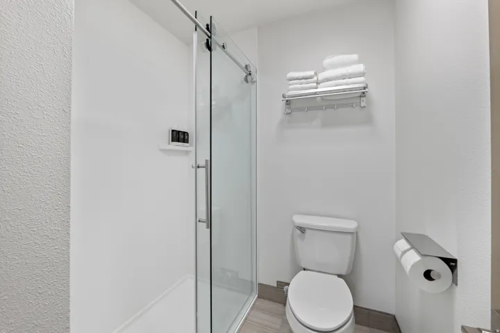 Bathroom featuring a stall shower and toilet