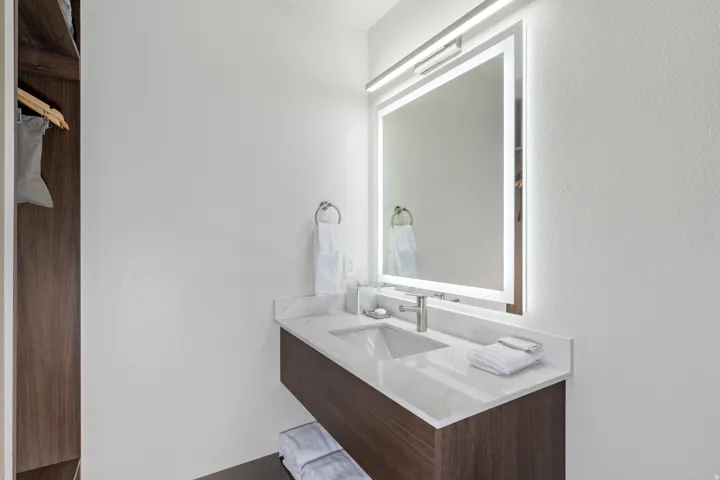 Bathroom with vanity and a textured wall