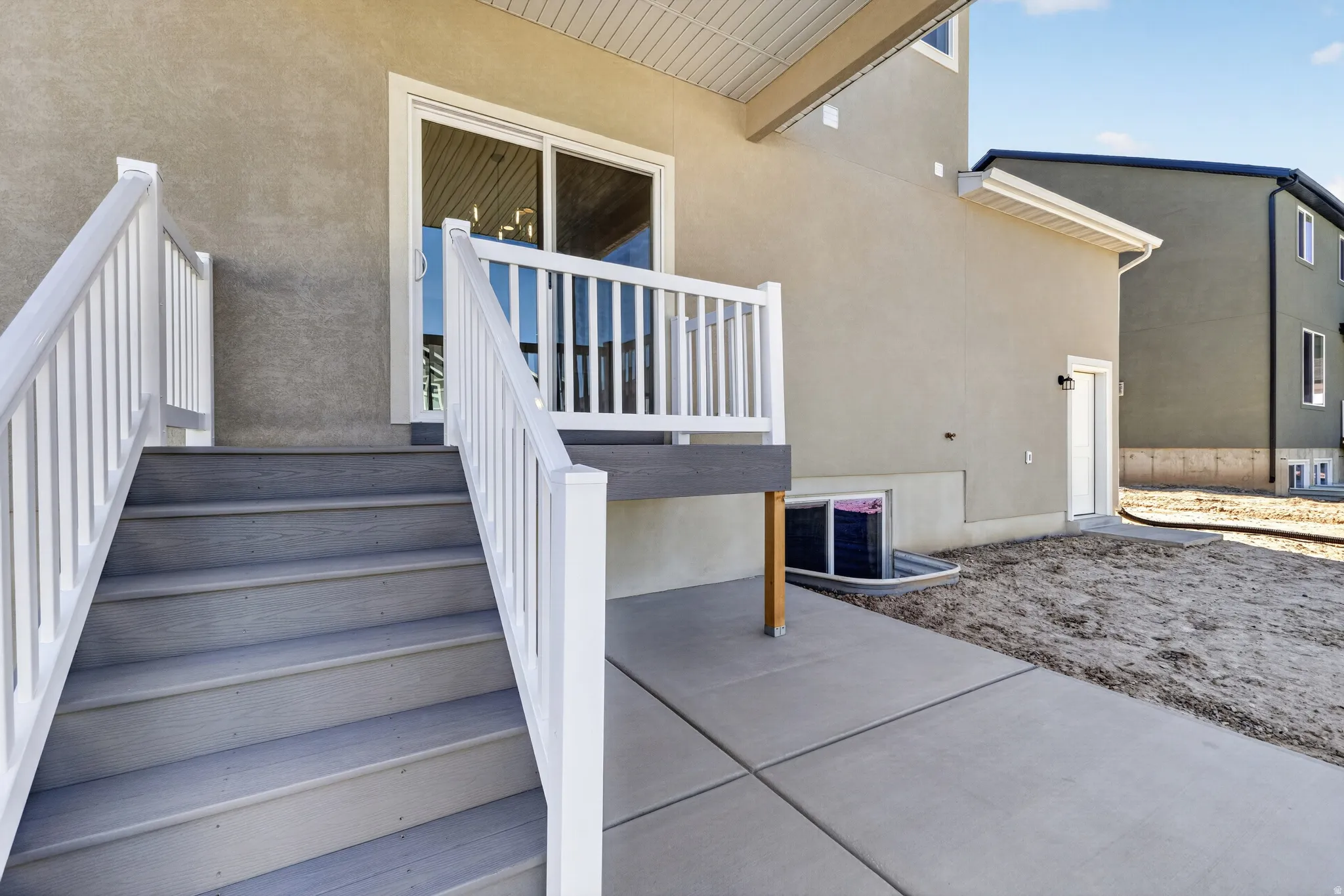 Exterior deck with white railings and gray composite stairs