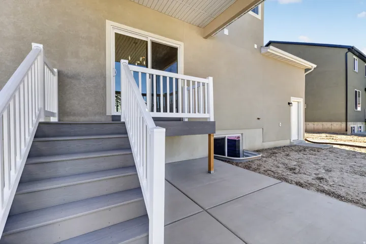 Exterior deck with white railings and gray composite stairs