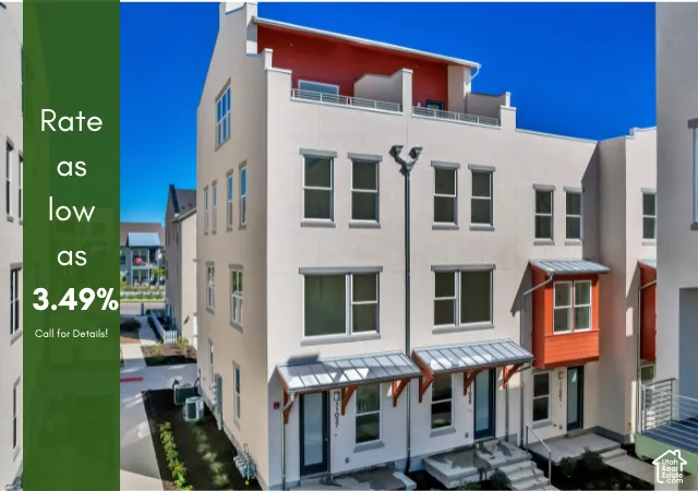 Multi-level exterior with a flat roofline, neutral stucco facade, and red accent paneling