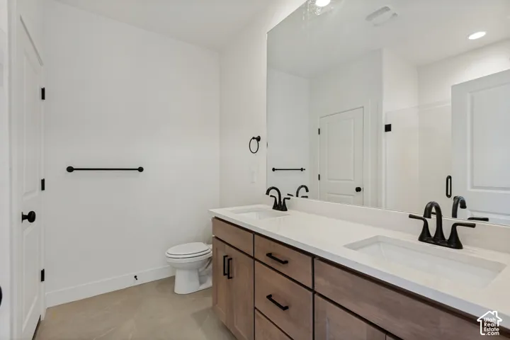 Dual vanity with integrated rectangular sinks, wood-finish cabinetry, and matte black fixtures