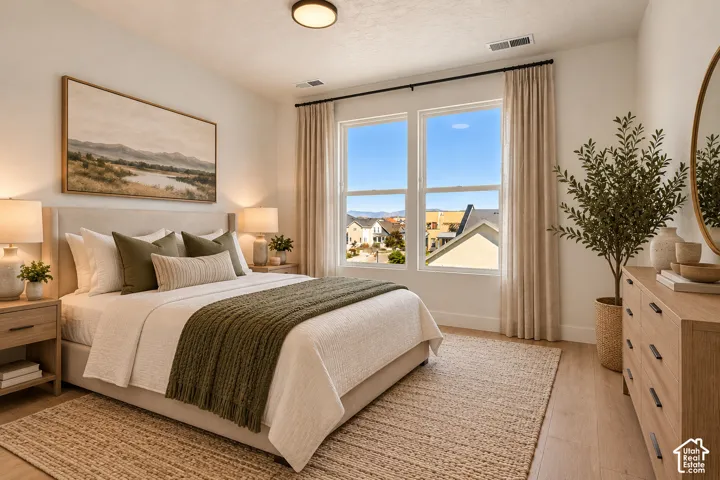 White walls, recessed lighting, and wood-finish flooring