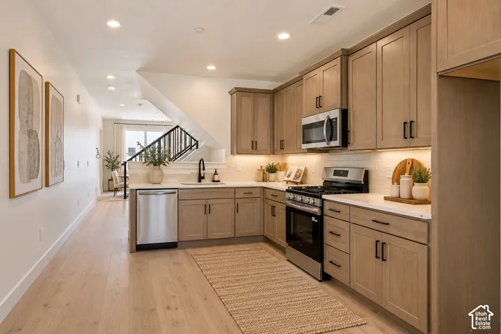 Kitchen featuring wood-finish cabinetry, stainless steel appliances, and solid surface countertops