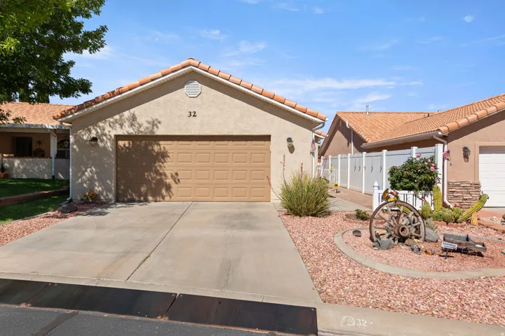 Mediterranean / spanish-style home with stucco siding, concrete driveway, an attached garage, and a tiled roof