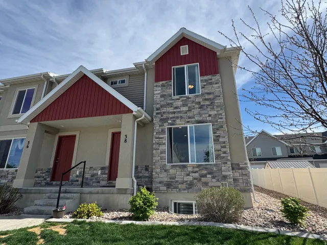 Craftsman-style house featuring stone siding, board and batten siding, and covered porch