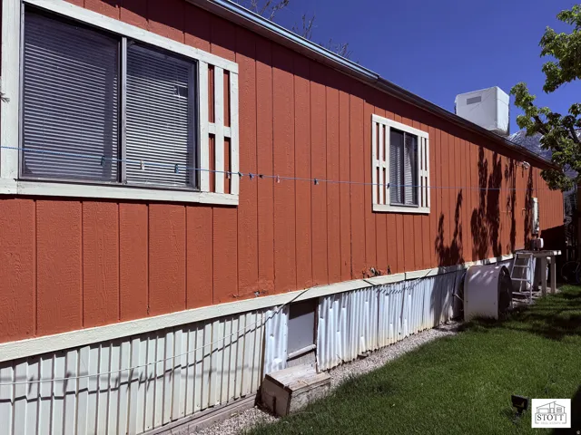 View of property exterior featuring heating fuel and a yard
