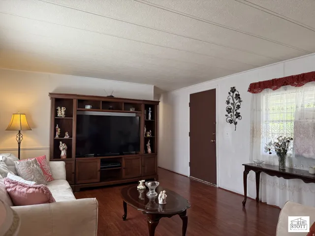 Living area with wood finished floors and a textured ceiling