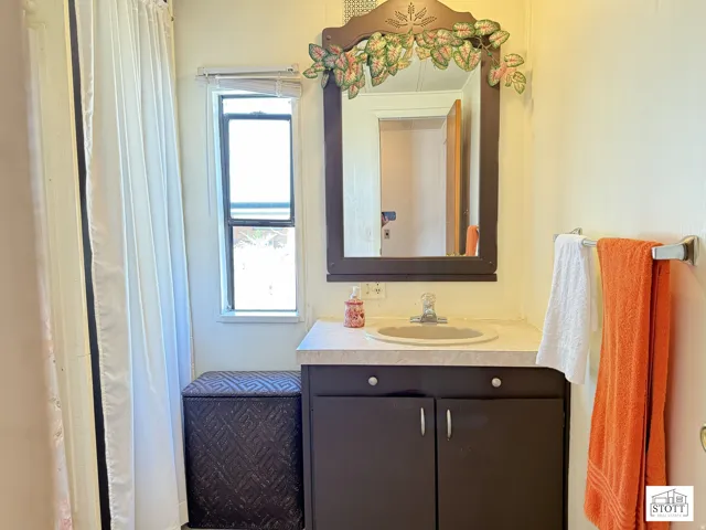 Full bath featuring vanity and a shower with curtain