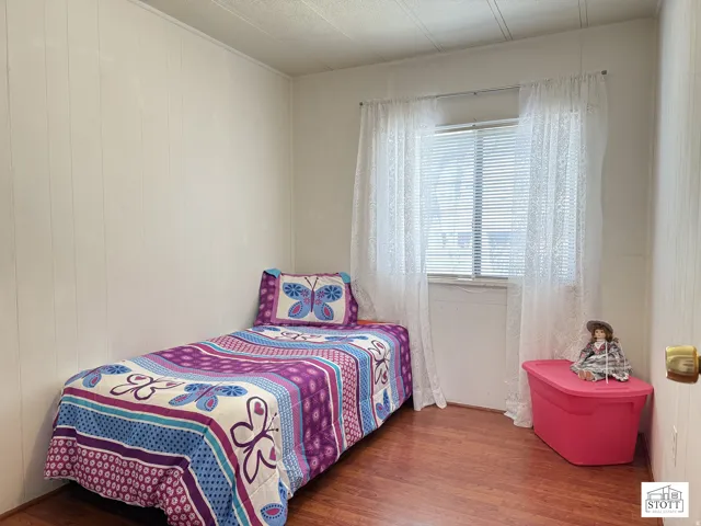 Bedroom with wood finished floors