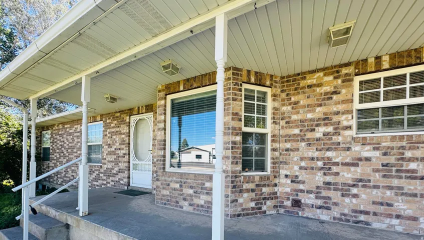 Brick exterior with a covered porch