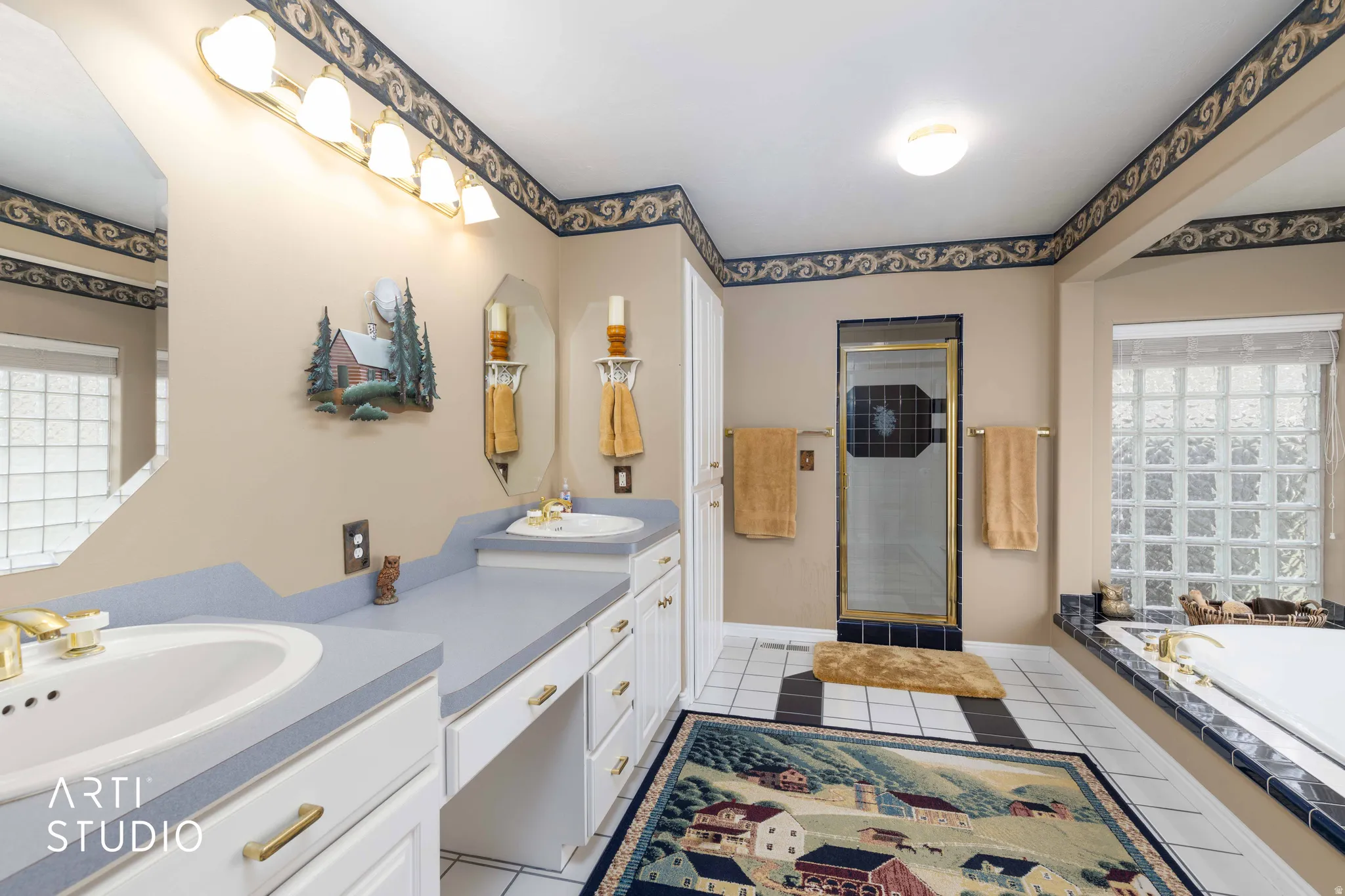 Bathroom featuring healthy amount of natural light, double vanity, a shower stall, and a bath