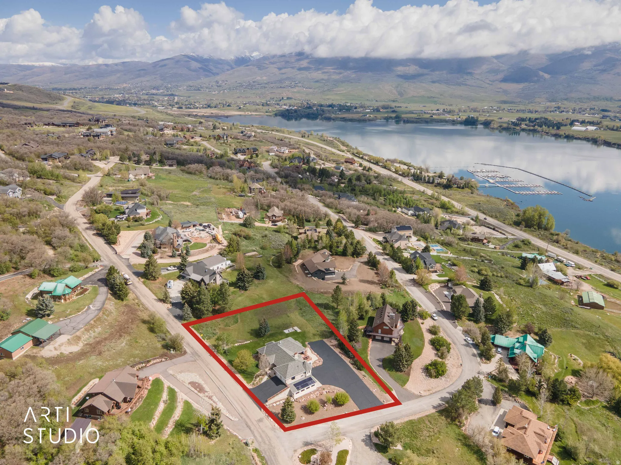 Aerial perspective of suburban area featuring a water and mountain view and property boundaries highlighted