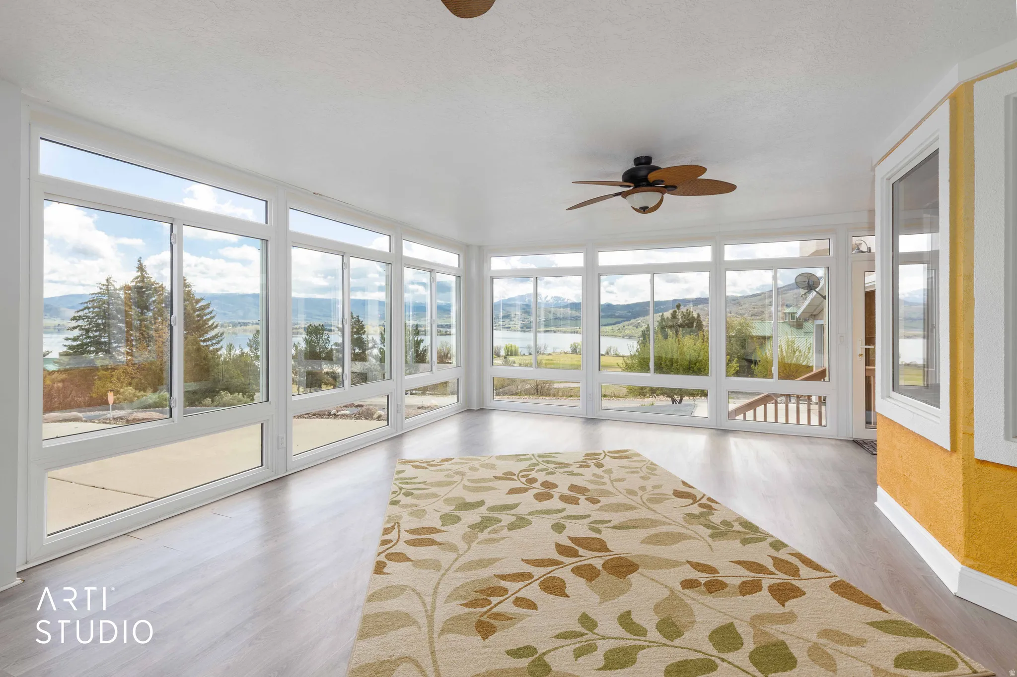 Unfurnished sunroom with expansive windows, a mountain view, and wood finished floors