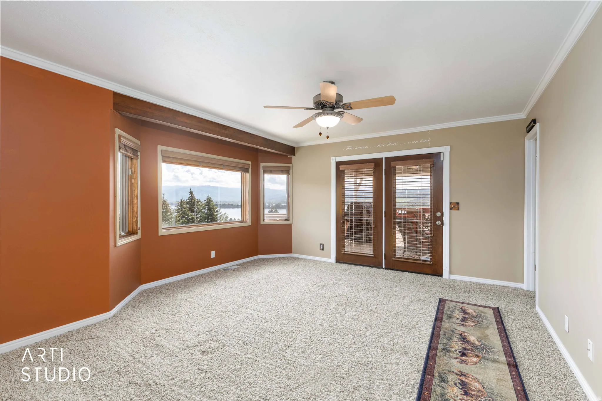 Unfurnished room featuring light carpet, a ceiling fan, healthy amount of natural light, and ornamental molding