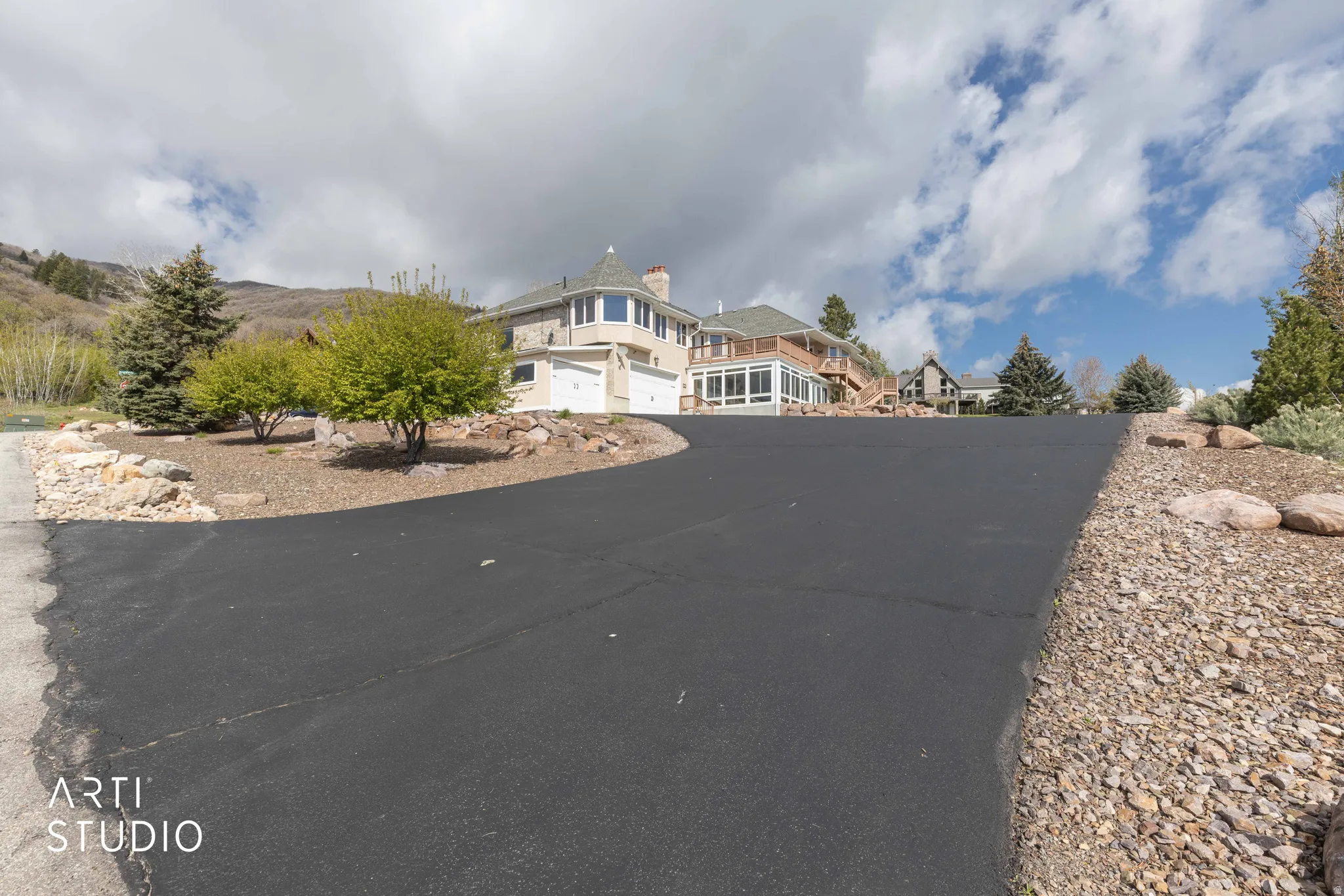 View of front of house featuring asphalt driveway and an attached garage