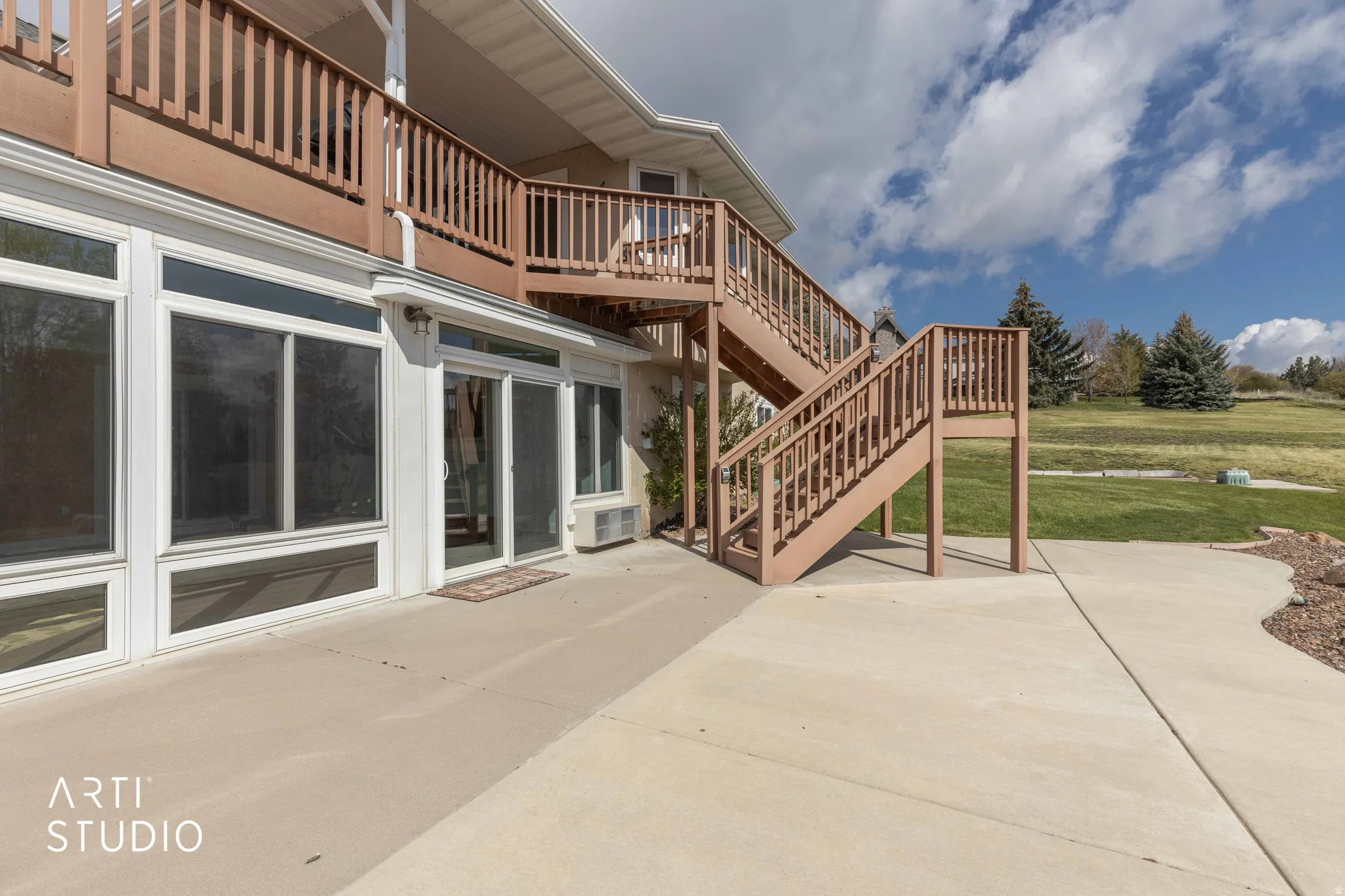 View of patio featuring stairs and a wooden deck