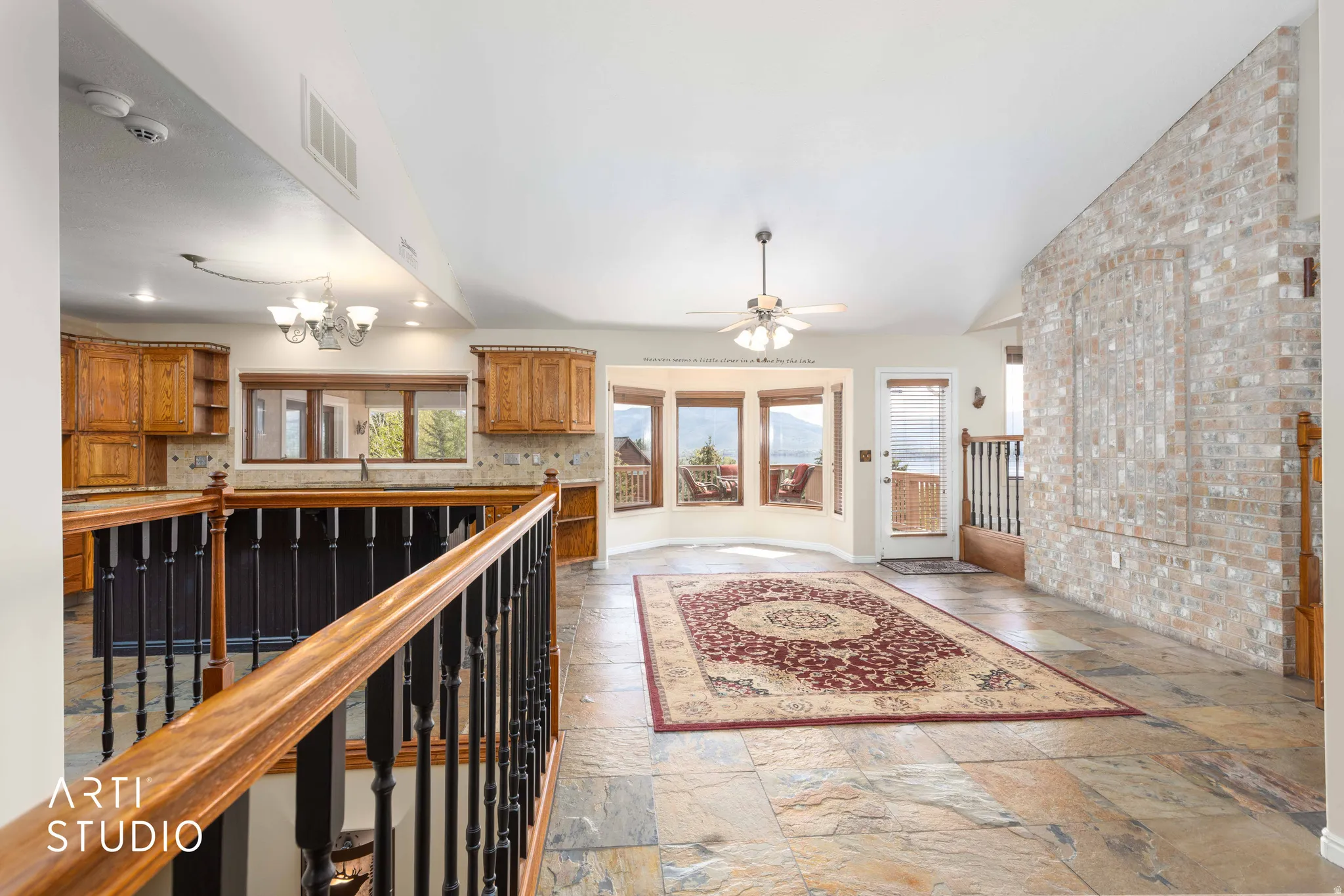 Corridor featuring a chandelier and stone tile floors