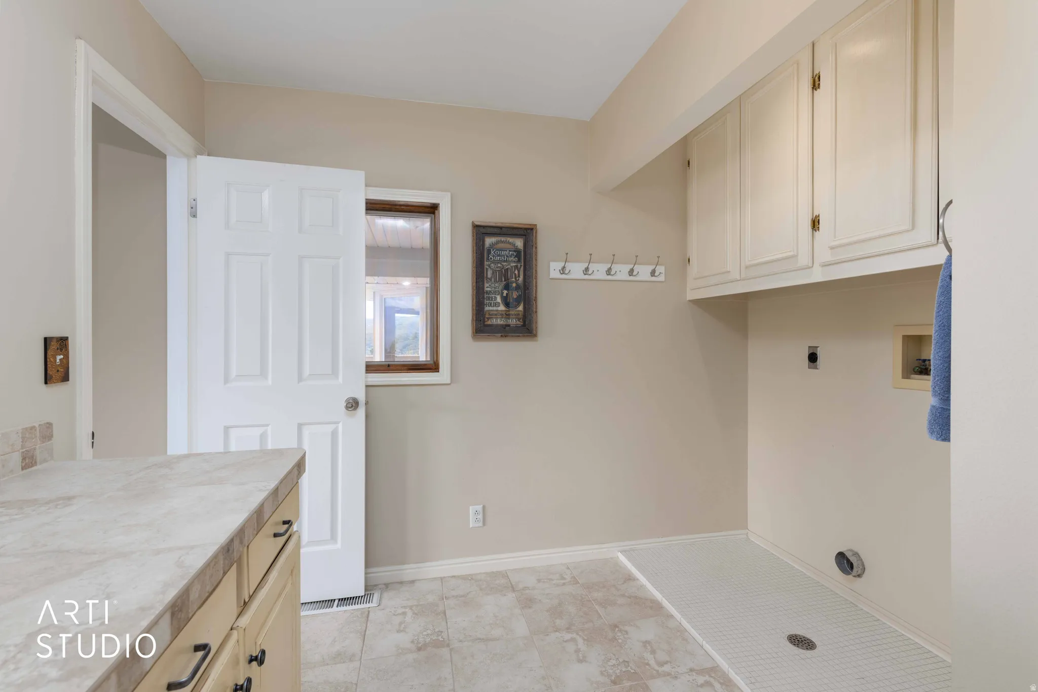 Laundry area featuring cabinet space, electric dryer hookup, and washer hookup