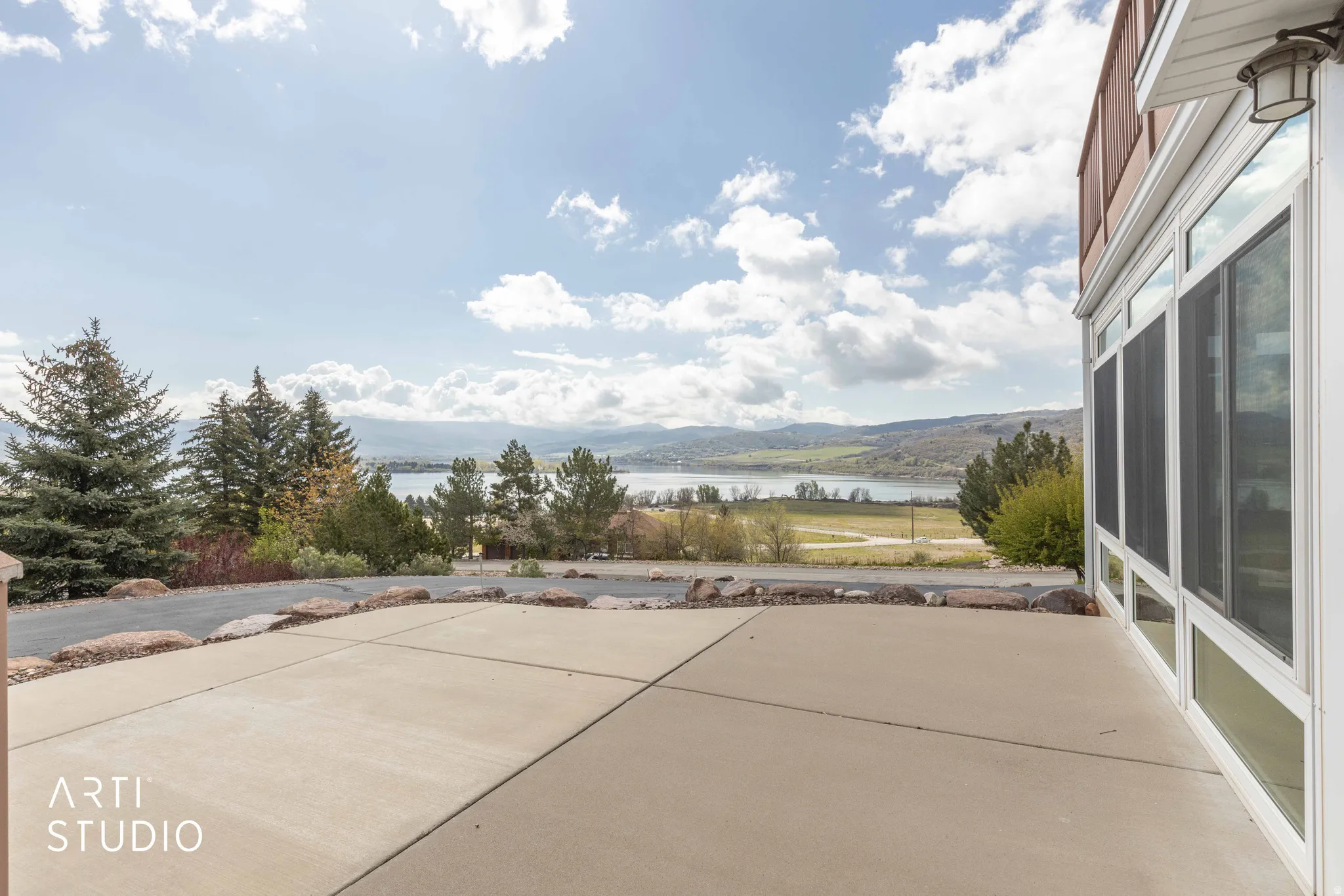 View of patio with a sunroom and a water view