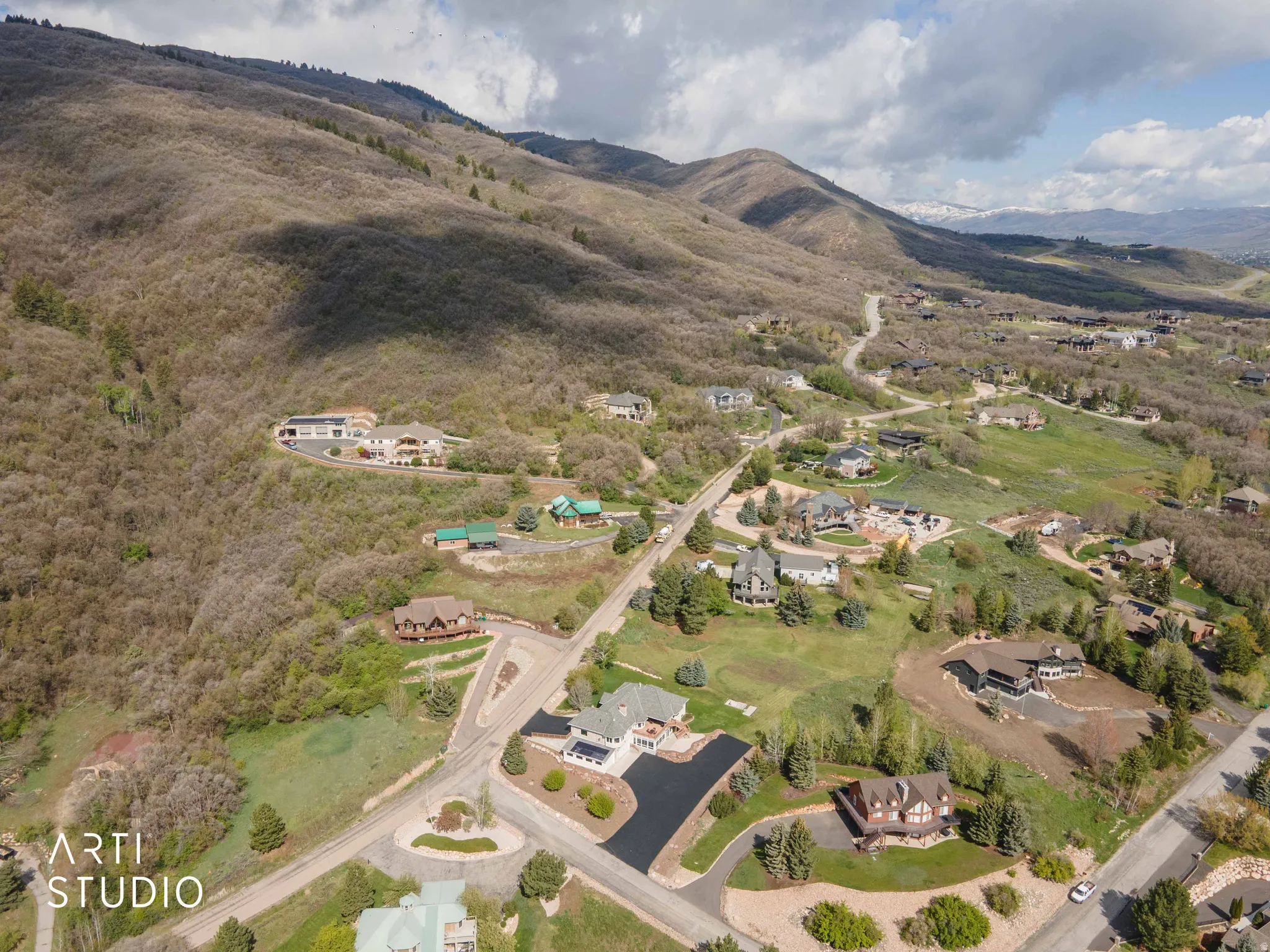 Aerial perspective of suburban area featuring a mountainous background