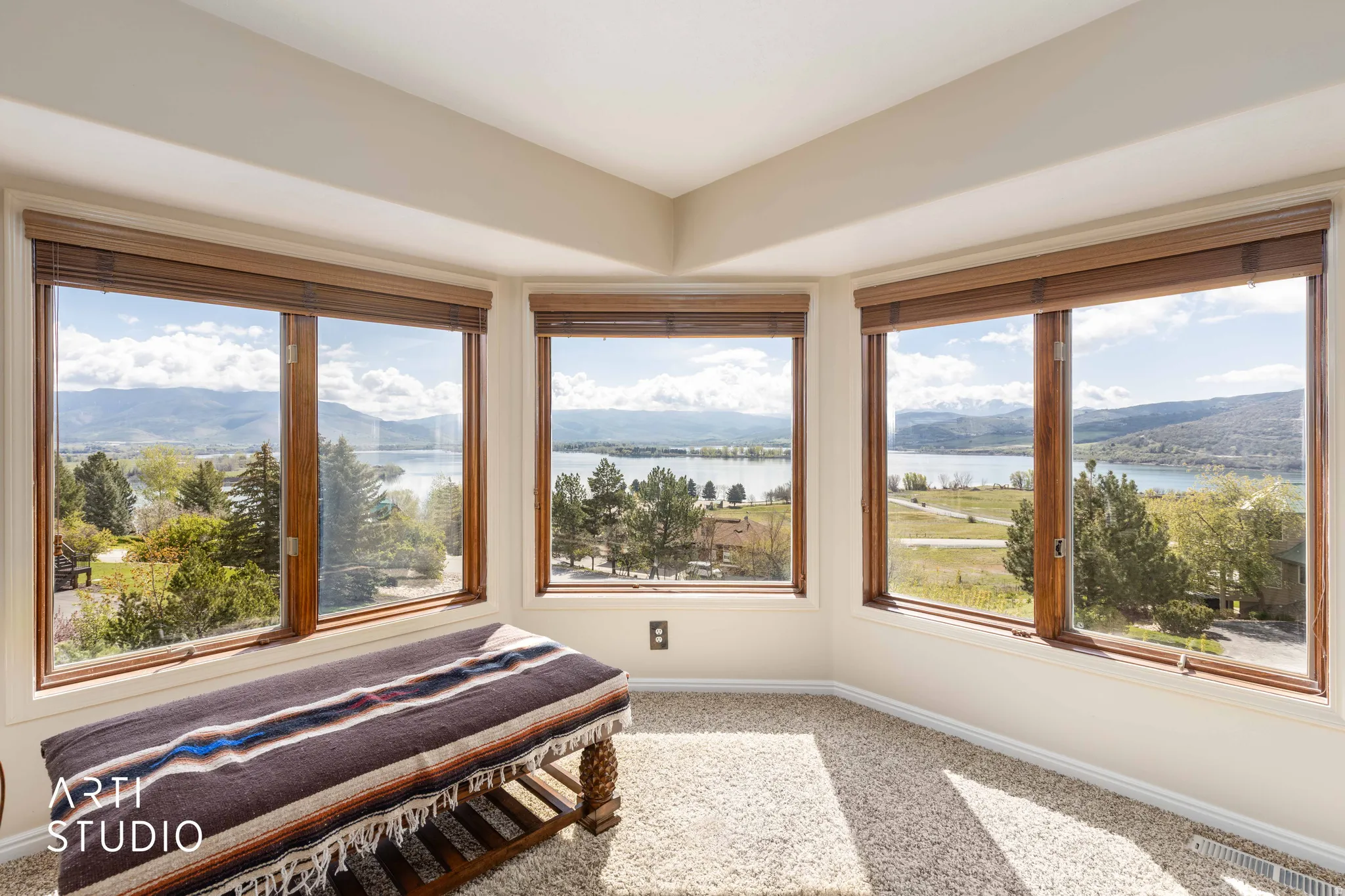 Sunroom / solarium featuring carpet floors and a water and mountain view