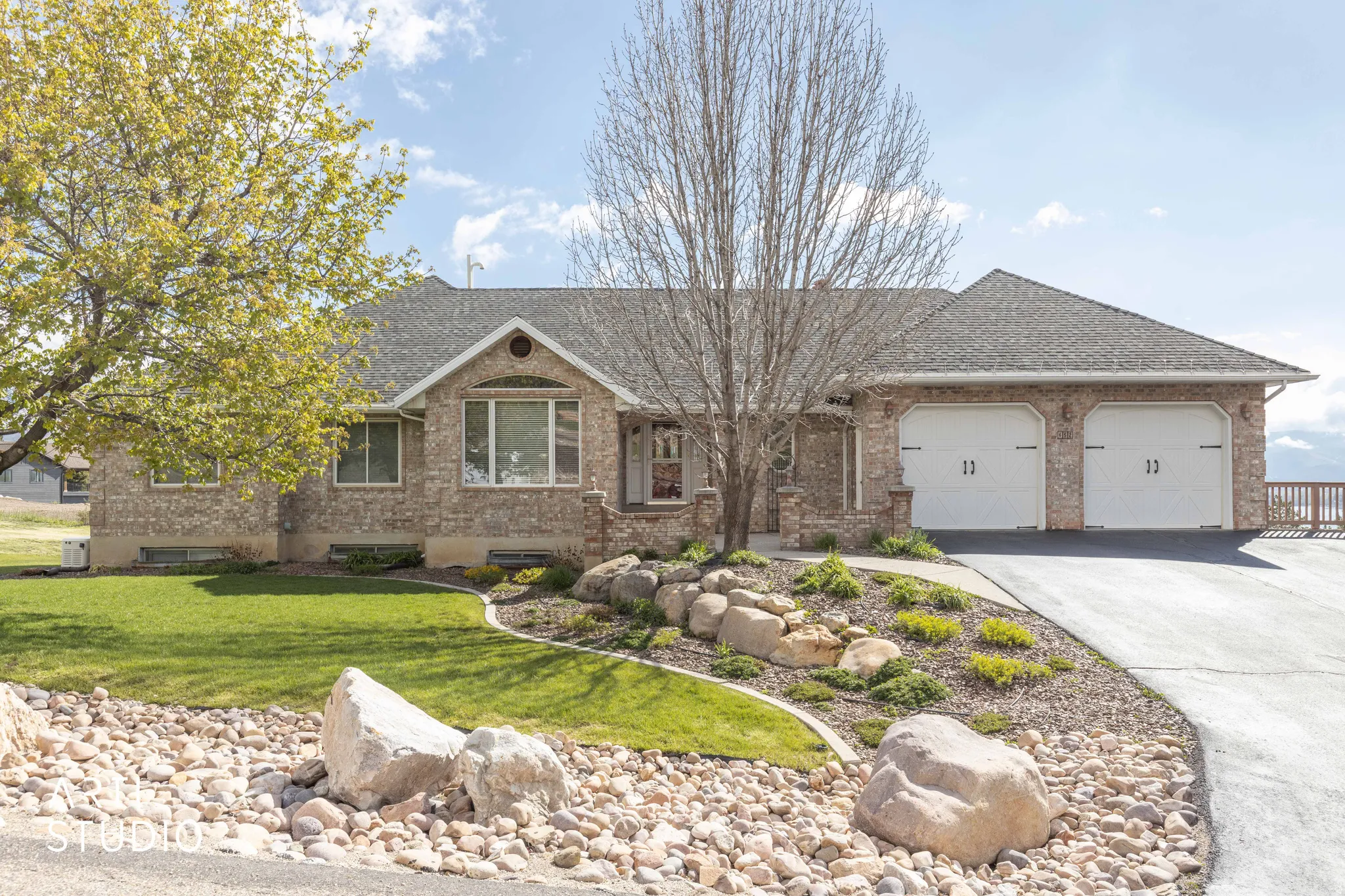 Single story home with brick siding, concrete driveway, a garage, and a shingled roof