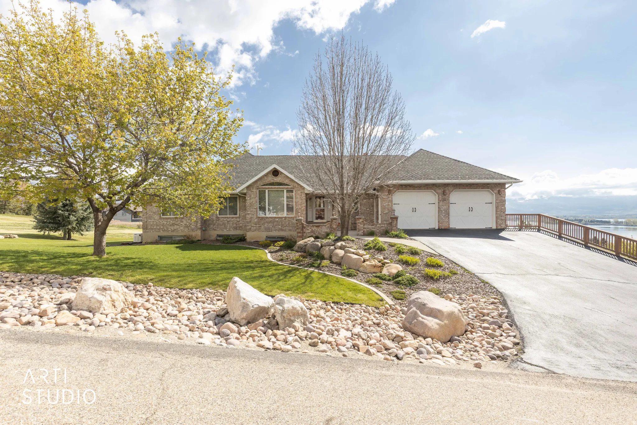 View of front of home featuring brick siding, concrete driveway, a front yard, a garage, and a shingled roof