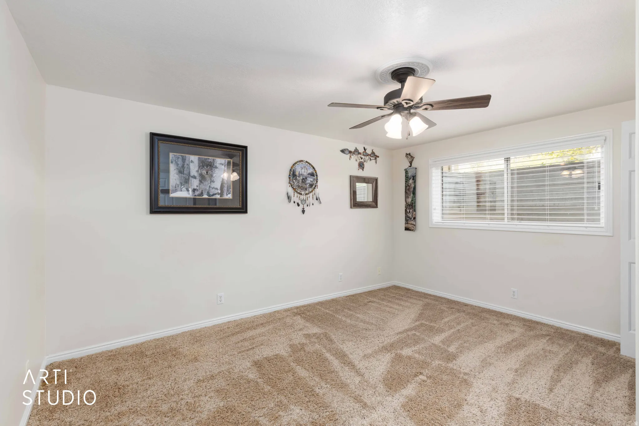 Empty room with carpet floors and ceiling fan