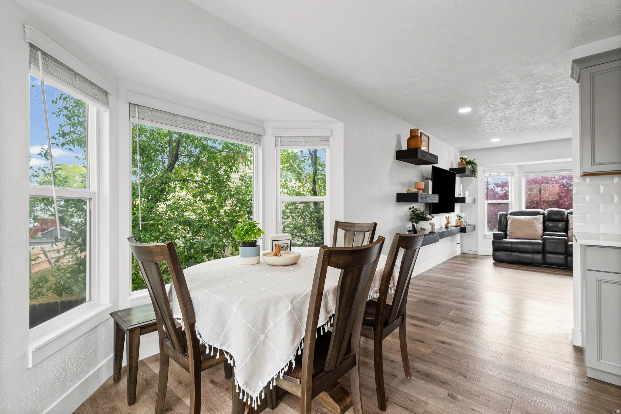 Dining space with wood finished floors and a textured ceiling