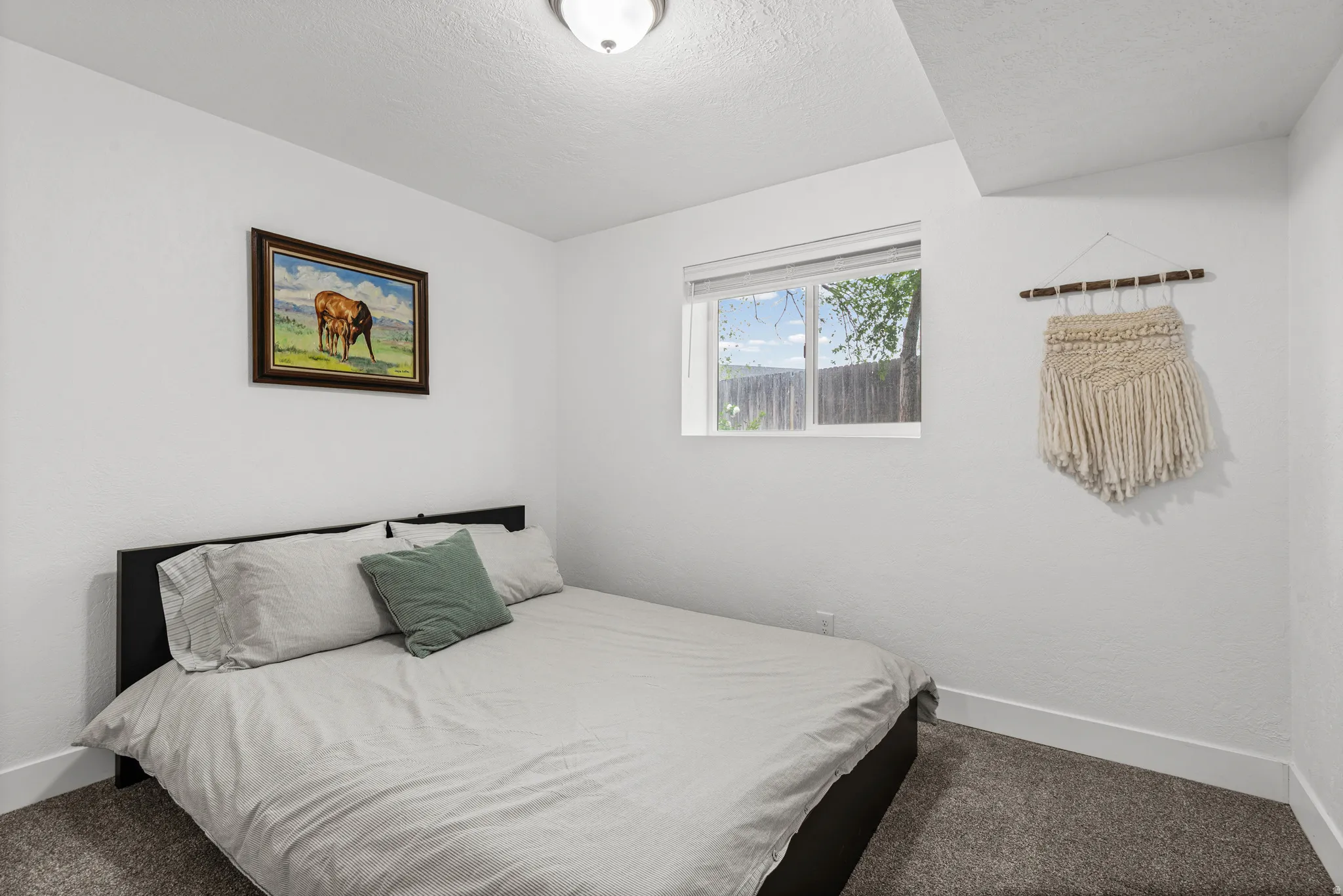 Bedroom featuring carpet floors and a textured ceiling